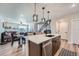 Open concept space featuring a kitchen island, dining area, and living room with a cozy sofa at 16433 Askins Loop, Parker, CO 80134