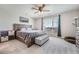 Comfortable main bedroom with a large window offering natural light, a wooden bed frame, and neutral-toned decor at 16433 Askins Loop, Parker, CO 80134