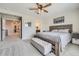 Comfortable main bedroom with a large window offering natural light, a wooden bed frame, and neutral-toned decor at 16433 Askins Loop, Parker, CO 80134