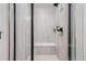 Contemporary shower featuring floor-to-ceiling tile, built-in bench, and glass doors, offering a luxurious bathing experience at 16433 Askins Loop, Parker, CO 80134
