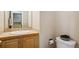Powder room featuring a stylish sink with tile and a toilet with decorative coal on the tank at 12421 Irving Dr, Broomfield, CO 80020