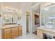 Bright bathroom featuring dual vanities, ample lighting, and a convenient walk-in shower at 12421 Irving Dr, Broomfield, CO 80020