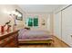Bedroom with wood floors, a window with a view of trees, and a large dresser at 12421 Irving Dr, Broomfield, CO 80020