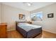 Bright bedroom features hardwood floors, ceiling fan, and a large window with views of the neighborhood at 12421 Irving Dr, Broomfield, CO 80020