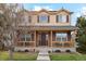 Charming two-story home featuring a welcoming front porch and well-maintained lawn at 12421 Irving Dr, Broomfield, CO 80020