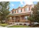 Charming two-story home featuring a welcoming front porch and well-maintained lawn at 12421 Irving Dr, Broomfield, CO 80020