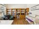 Comfortable living room featuring a wooden bookcase, piano and reading chair at 12421 Irving Dr, Broomfield, CO 80020