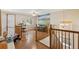 Loft with wood floors, a ceiling fan, and views of the outdoors at 12421 Irving Dr, Broomfield, CO 80020