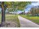 Beautiful walking path winding through lush green spaces and mature trees in a peaceful neighborhood at 12421 Irving Dr, Broomfield, CO 80020