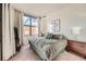 Spacious bedroom with large window and plush bedding at 180 Cook St # 105, Denver, CO 80206