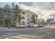 Condo building exterior showcasing urban setting and ample parking at 180 Cook St # 105, Denver, CO 80206