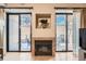 Gas fireplace with built-in shelving and access to a private patio at 180 Cook St # 105, Denver, CO 80206