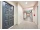 Well-lit hallway with carpeted floors and modern apartment doors at 180 Cook St # 105, Denver, CO 80206