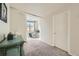 A hallway with light carpet, and a view of the bedroom at 180 Cook St # 105, Denver, CO 80206