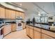 Well-equipped kitchen featuring light wood cabinets and granite countertops at 180 Cook St # 105, Denver, CO 80206