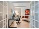 Home office with hardwood floors, a glass desk, and comfortable seating at 180 Cook St # 105, Denver, CO 80206