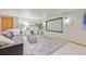 Cozy basement theatre room with a projector screen and comfortable seating at 5528 S Jasper Way, Centennial, CO 80015
