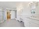 Bright bathroom featuring dual vanities, a walk-in shower, and a large closet with sliding barn door at 5528 S Jasper Way, Centennial, CO 80015