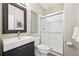 Modern bathroom featuring sleek vanity, framed mirror, and glass-enclosed shower at 5528 S Jasper Way, Centennial, CO 80015
