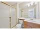 Bathroom showcasing a tiled shower and vanity with a wood finish at 5528 S Jasper Way, Centennial, CO 80015