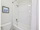 Tiled shower-tub combination with white subway tile at 5528 S Jasper Way, Centennial, CO 80015