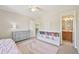 Bright bedroom featuring built-in bookshelves and an adjacent bathroom at 5528 S Jasper Way, Centennial, CO 80015