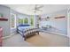 Bright bedroom featuring a bay window, desk, and ceiling fan at 5528 S Jasper Way, Centennial, CO 80015