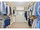 Spacious walk-in closet with custom shelving and drawers for optimal organization and storage at 5528 S Jasper Way, Centennial, CO 80015
