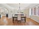 Elegant dining room with hardwood floors, white trim and large windows for natural light at 5528 S Jasper Way, Centennial, CO 80015