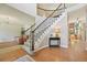 Elegant foyer showcasing a curved staircase with wood railings, and hardwood floors at 5528 S Jasper Way, Centennial, CO 80015