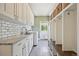 Well-appointed laundry room with ample storage, sink, and modern appliances at 5528 S Jasper Way, Centennial, CO 80015