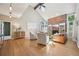 Bright living room featuring a vaulted ceiling, brick fireplace, and hardwood floors at 5528 S Jasper Way, Centennial, CO 80015