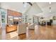 Spacious living room with a brick fireplace, vaulted ceiling, hardwood floors, and a seamless layout at 5528 S Jasper Way, Centennial, CO 80015