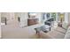 Bright second living area with a sitting area, large windows, and a calming color scheme at 5528 S Jasper Way, Centennial, CO 80015