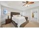 Comfortable main bedroom featuring plush bedding, tray ceilings, and ensuite access at 5528 S Jasper Way, Centennial, CO 80015