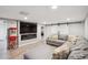 Basement rec room with electric fireplace, TV, and comfortable seating at 2664 Forest St, Denver, CO 80207
