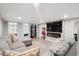 Finished basement with a large sectional couch, TV and electric fireplace at 2664 Forest St, Denver, CO 80207