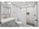 Bathroom featuring white subway tile walk-in shower, modern sink with vanity, and updated fixtures at 2664 Forest St, Denver, CO 80207