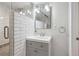 Bathroom featuring white subway tile walk-in shower, modern sink with vanity, and updated fixtures at 2664 Forest St, Denver, CO 80207