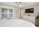 Bedroom featuring a large bed with fan, closet, and dresser with TV at 2664 Forest St, Denver, CO 80207