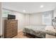 Cozy bedroom with wood laminate flooring, window and dresser with television at 2664 Forest St, Denver, CO 80207