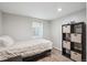 Spare bedroom with wood laminate flooring and storage unit with containers at 2664 Forest St, Denver, CO 80207