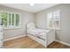Bright bedroom featuring hardwood floors and white shutters, with white daybed at 2664 Forest St, Denver, CO 80207