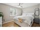 Comfortable bedroom featuring a white bed, ceiling fan, and natural light at 2664 Forest St, Denver, CO 80207