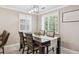 Elegant dining room with modern lighting, large windows, and seating for six at 2664 Forest St, Denver, CO 80207