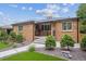 A well-kept lawn, neat landscaping, and a brick exterior give this home great curb appeal at 2664 Forest St, Denver, CO 80207