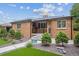 Beautiful brick home boasting manicured landscaping, a well-maintained lawn, and an inviting entrance at 2664 Forest St, Denver, CO 80207