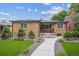 Charming brick home features a well-manicured lawn, walkway, and inviting front porch at 2664 Forest St, Denver, CO 80207