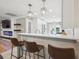 Stylish kitchen with white cabinets, modern pendants, and a breakfast bar for casual dining at 2664 Forest St, Denver, CO 80207