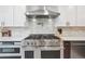 Modern kitchen features a stainless steel range hood and a professional gas cooktop at 2664 Forest St, Denver, CO 80207
